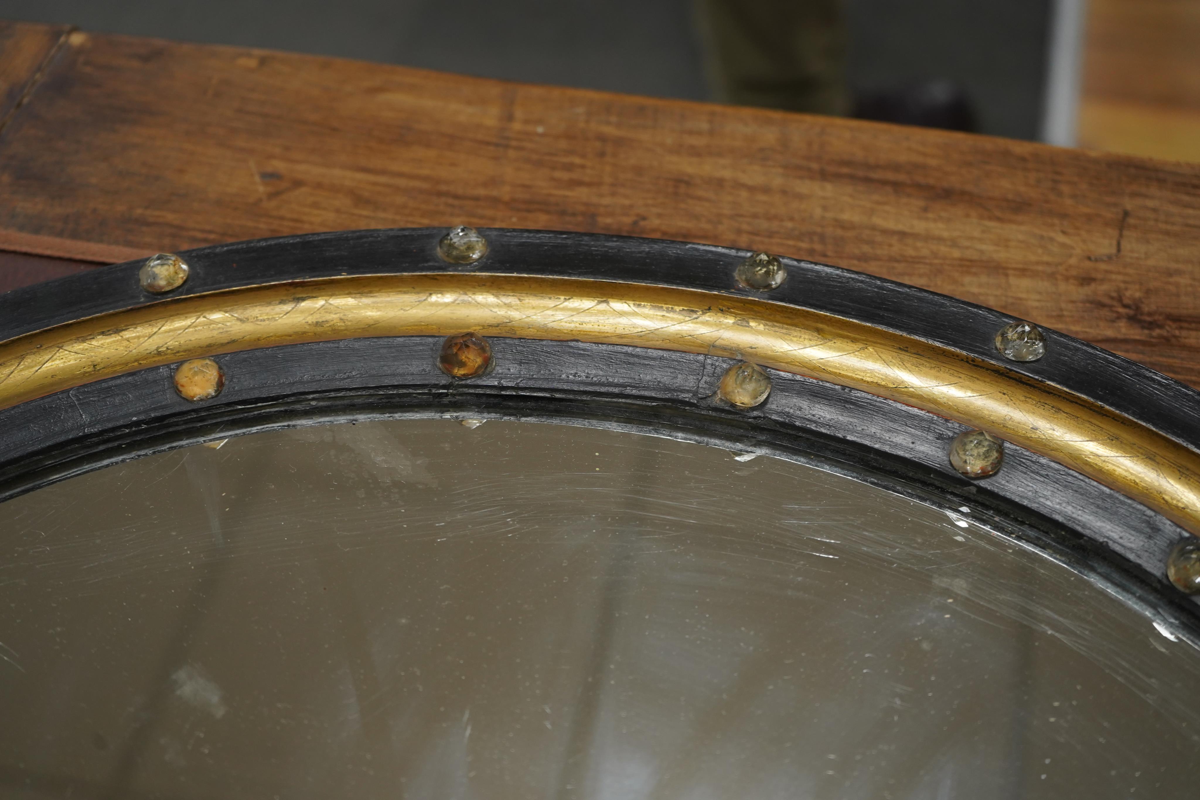 A 19th century oval Irish wall mirror, width 54cm, height 62cm. Condition - fair